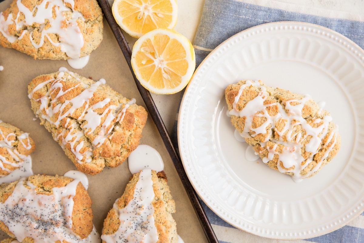 top down photo of baking sheet of scones with a plate with a scone on top next to it