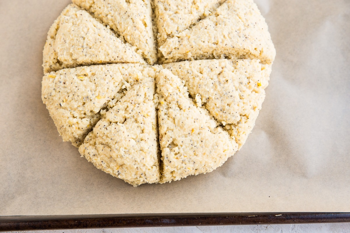 Baking sheet with disc of scone dough cut into 8 triangles