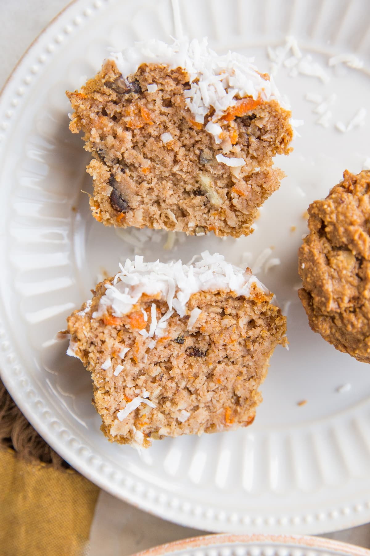 Carrot Cake Muffin sliced in half on a plate so you can see the inside