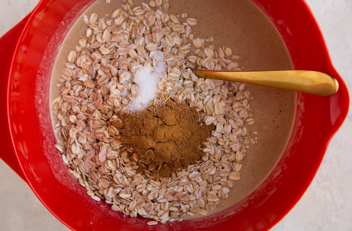 Oats in a mixing bowl with wet ingredients