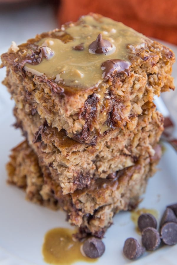 Close up photo of a stack of three slices of peanut butter banana baked oatmeal