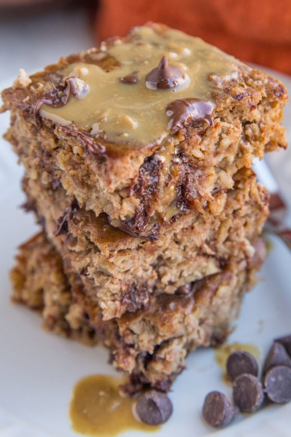 Close up photo of a stack of three slices of peanut butter banana baked oatmeal