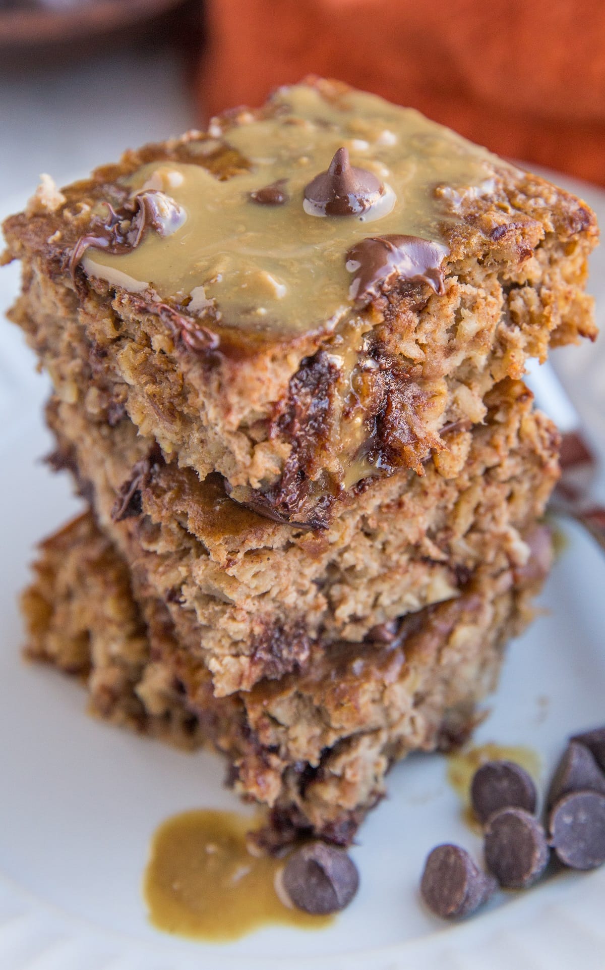 Close up photo of a stack of three slices of peanut butter banana baked oatmeal