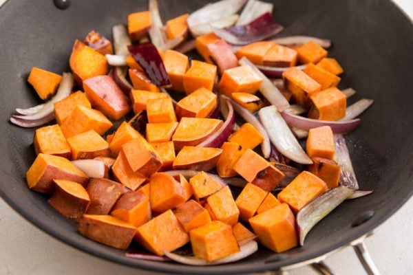 Sweet potatoes and onions in a skillet