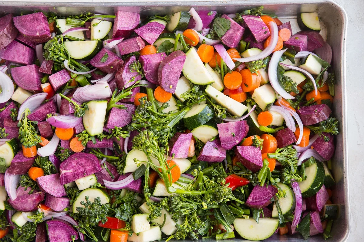 huge casserole dish filled with raw vegetables, ready to be roasted