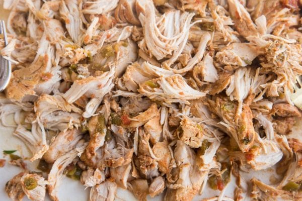 Shredded chicken on a cutting board