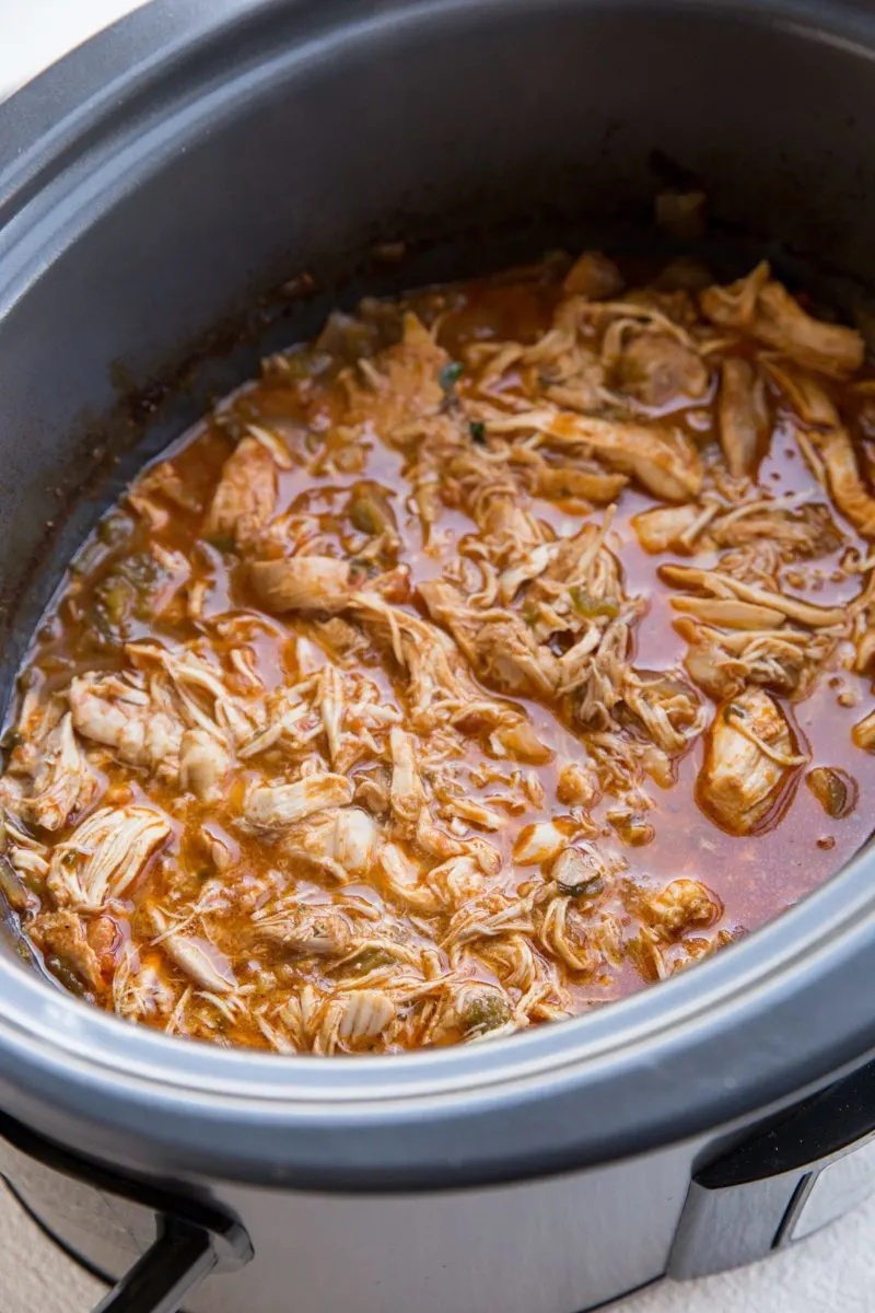 Slow cooker with shredded Mexican chicken inside