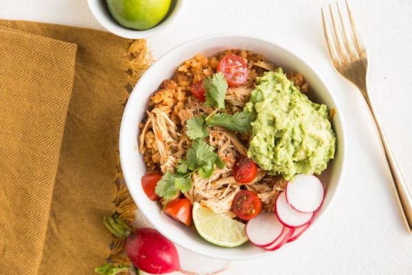burrito bowl with Spanish rice, shredded chicken and guacamole