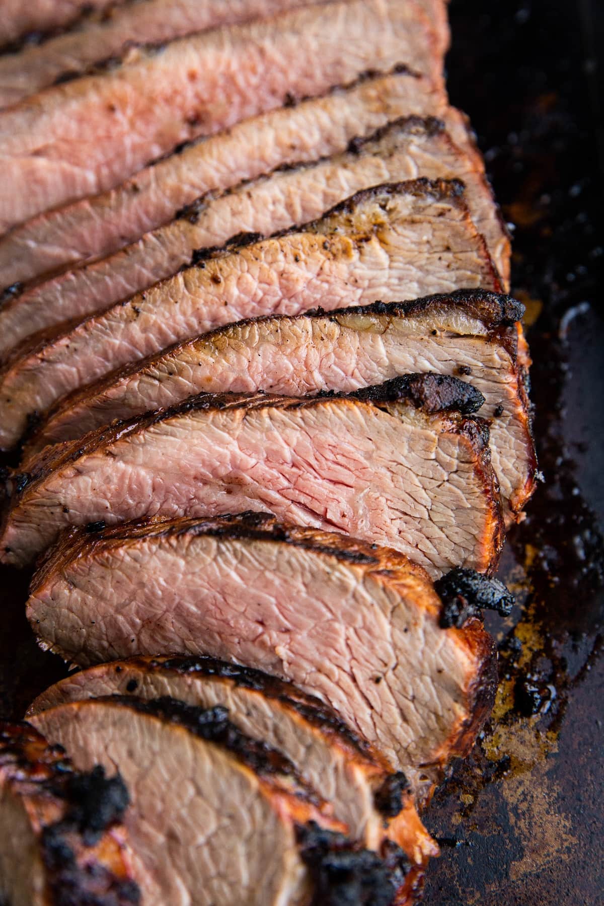 Sliced tri tip on a baking sheet.