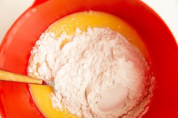 Dry ingredients on top of wet ingredients in a mixing bowl