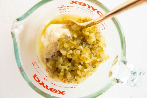 Ingredients for creamy potato salad dressing in a measuring cup.