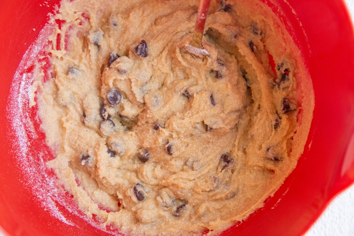 Chocolate chip cookie dough in a mixing bowl