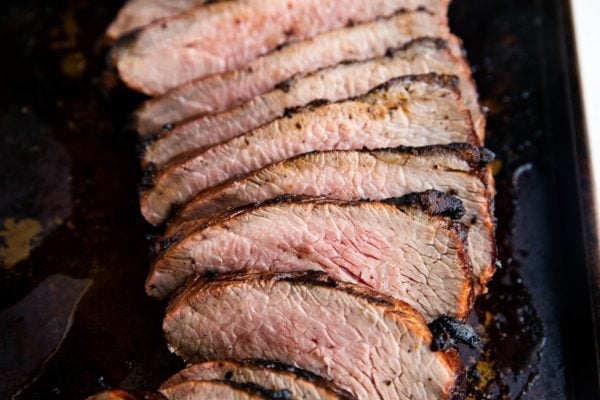 Sliced tri tip on a baking sheet