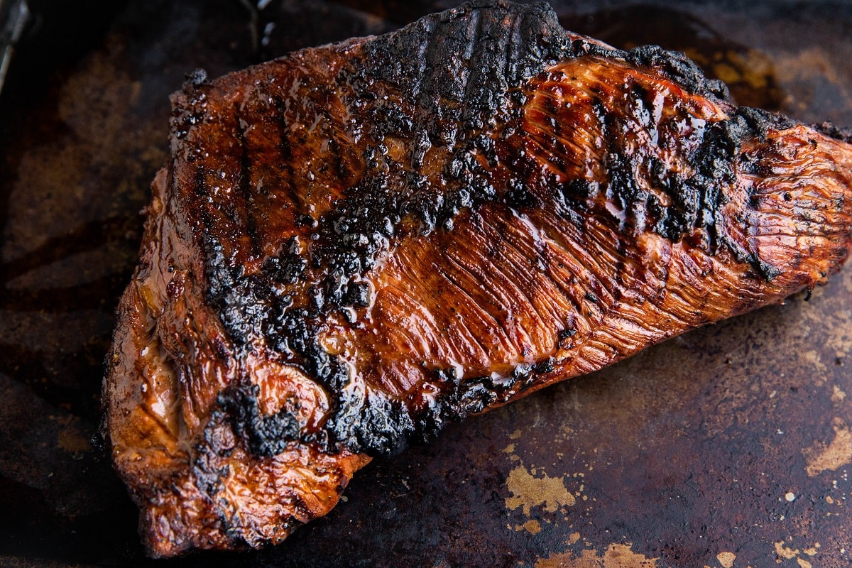 Tri tip resting on a baking sheet.