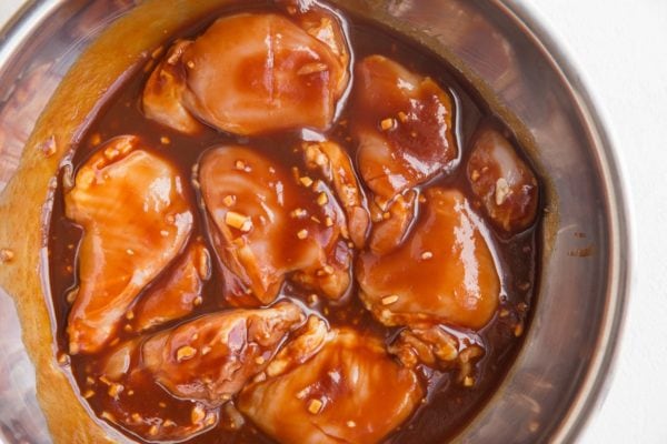 Mixing bowl with chicken thighs and Hawaiian BBQ marinade