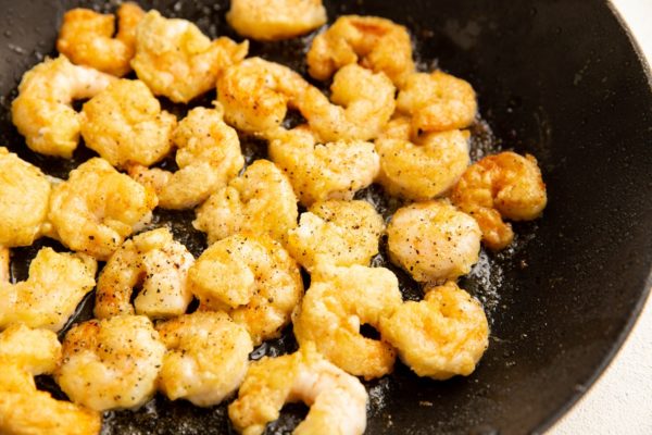 Crispy fried shrimp in a skillet