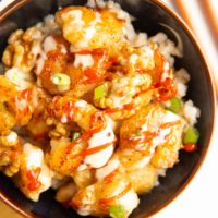 Bowl of Honey Walnut Shrimp with green onions on top