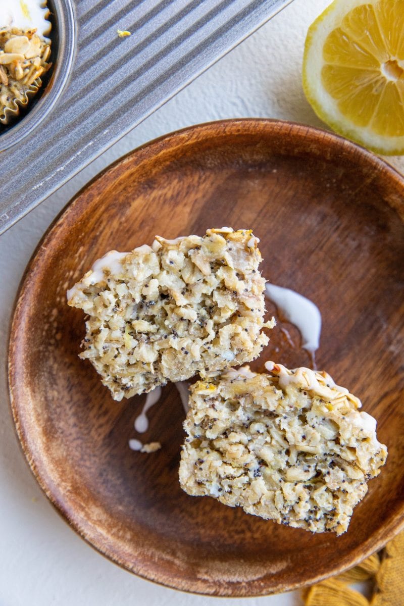 lemon poppy seed oatmeal muffin sliced in half on a plate so that you can see the inside.