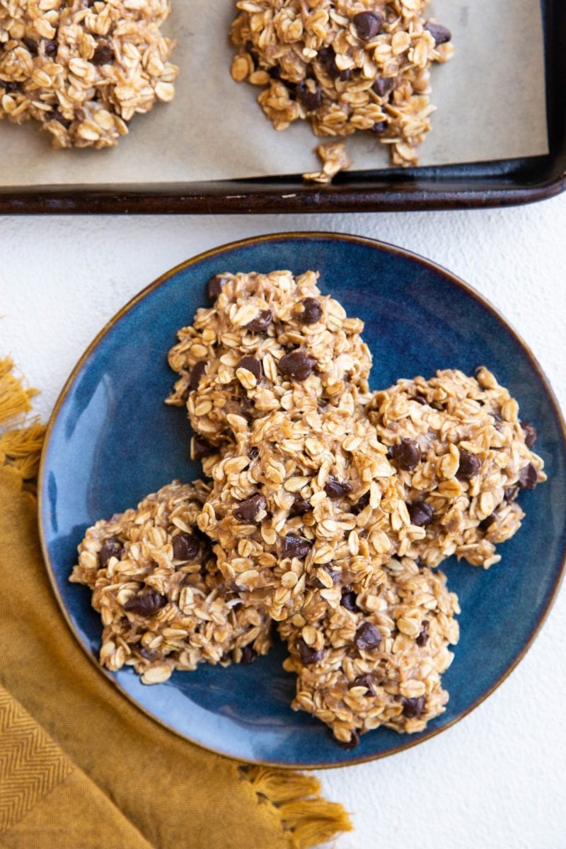 Plate and cookie tray of banana oatmeal cookies with a golden napkin