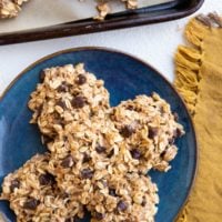 blue plate of no-bake banana cookies and a cookie tray of cookies