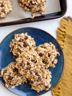 blue plate of no-bake banana cookies and a cookie tray of cookies