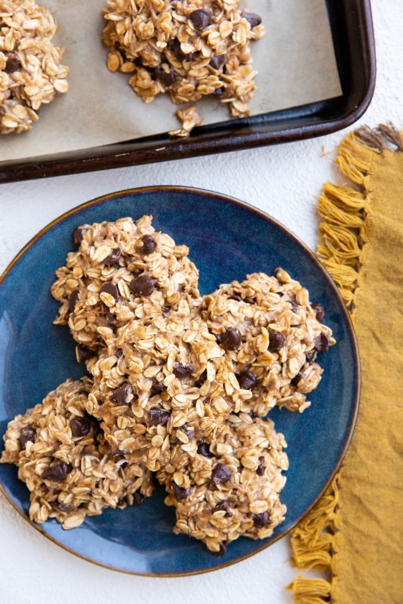 blue plate of no-bake banana cookies and a cookie tray of cookies