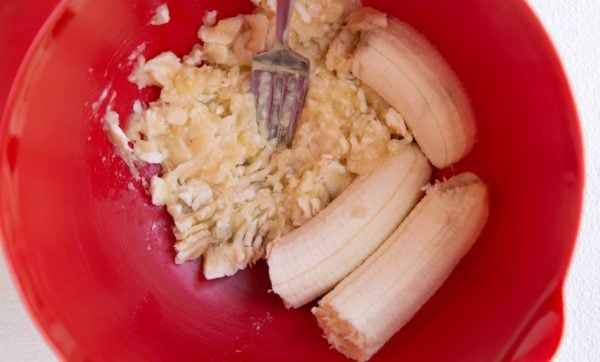 Mashed bananas in a mixing bowl