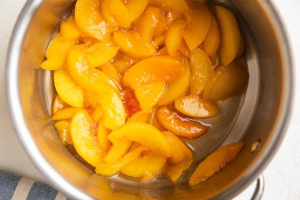 cooked peach pie filling in a saucepan