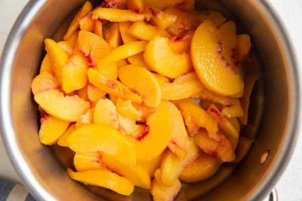Ingredients for peach pie filling in a saucepan