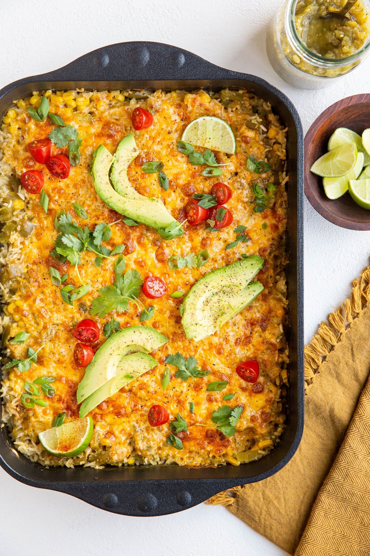 Beautiful photo of mexican chicken casserole with napkin and limes to the side