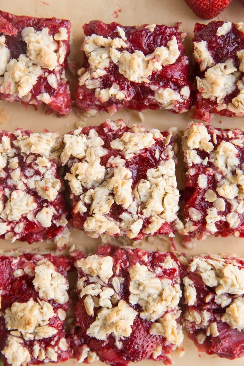 Strawberry Oatmeal Crumb Bars on a sheet of parchment paper.