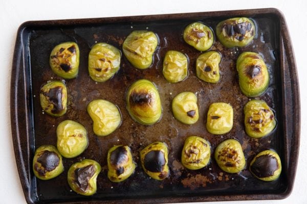 Roasted tomatillos on a baking sheet fresh out of the oven.