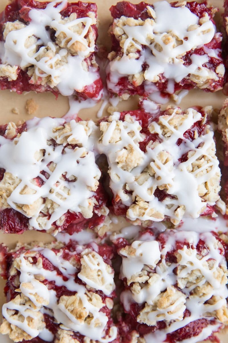 Top down image of gluten-free strawberry bars cut into individual portions with a glaze on top