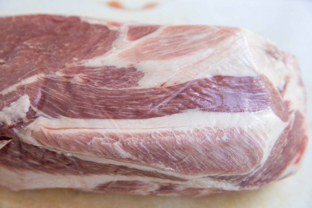 boneless pork shoulder roast on a cutting board