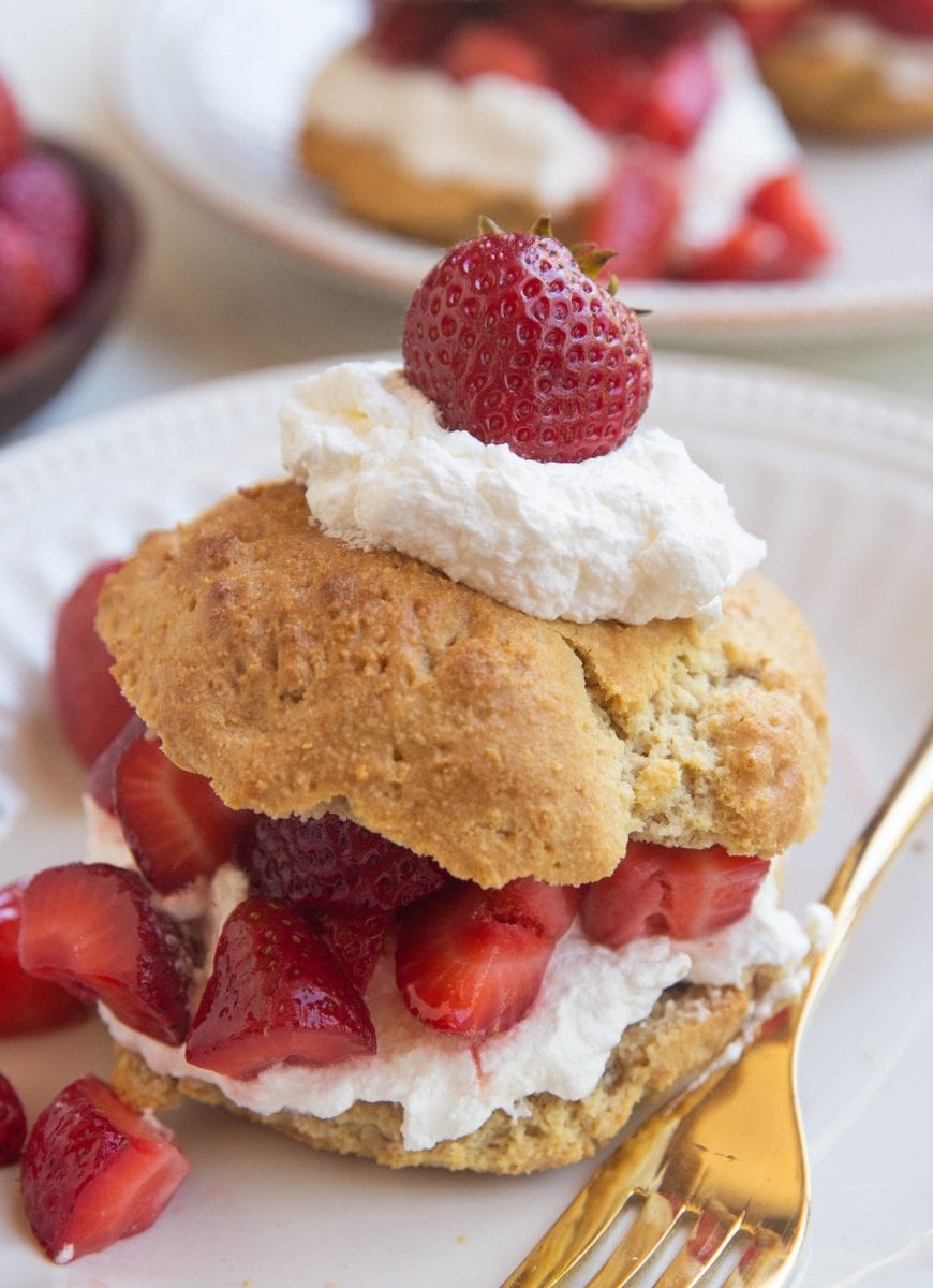 close up image of strawberry shortcake on a white plate