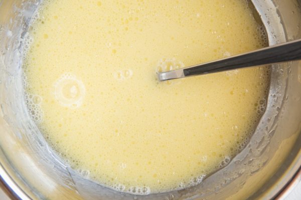 Wet ingredients for waffles in a mixing bowl