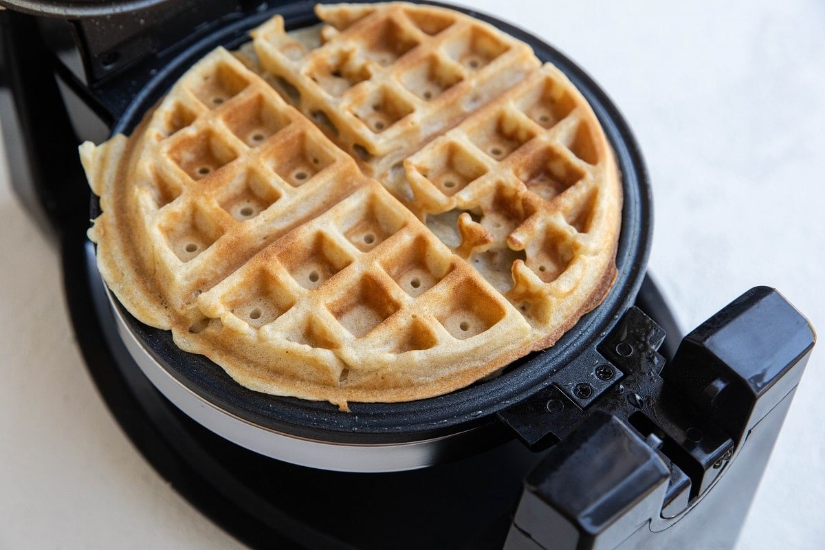 Waffle maker with finished waffle all golden brown and perfect