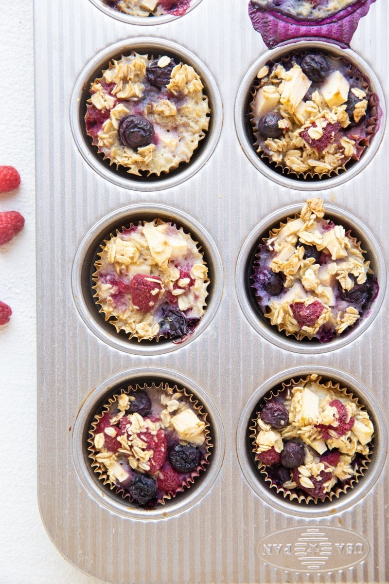 Berry baked oatmeal muffins in a muffin tin