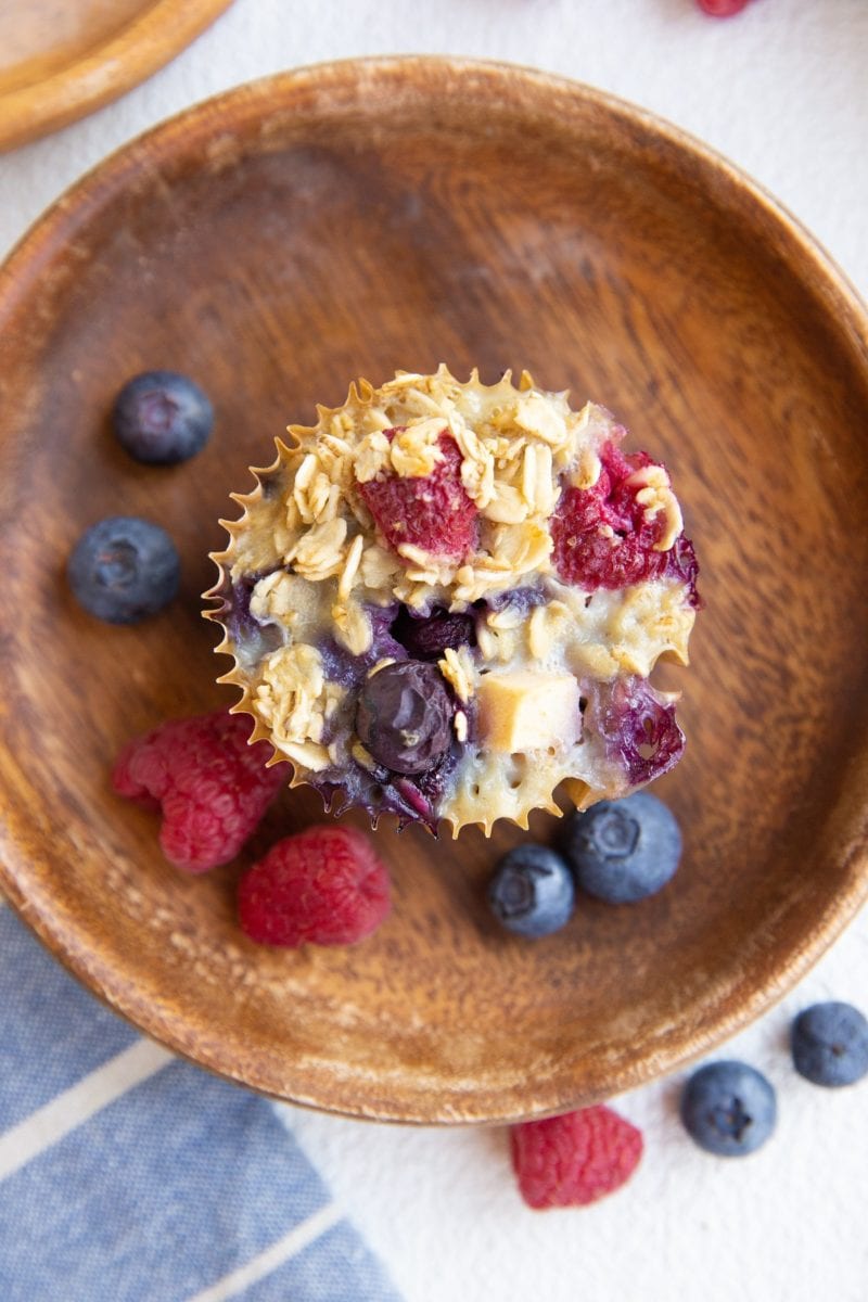 Berry baked oatmeal muffin on a wooden plate