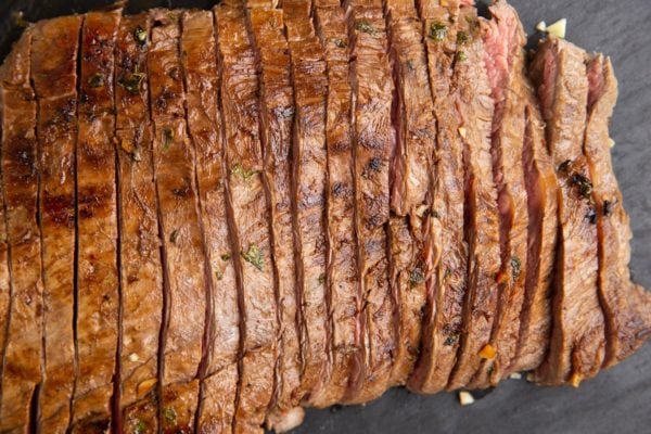 Carne asada on a cutting board, sliced