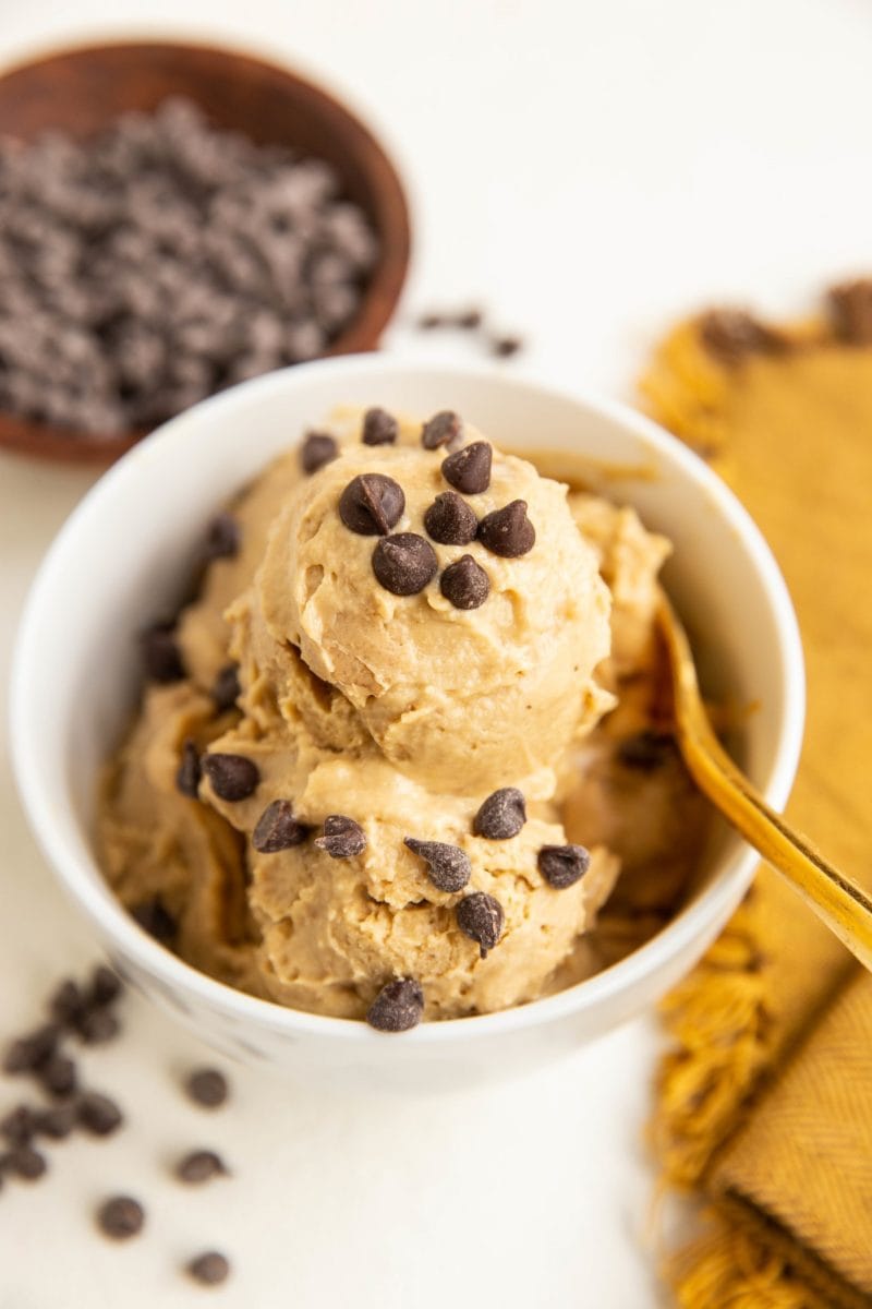 angle shot of bowl of chickpea ice cream with chocolate chips all around