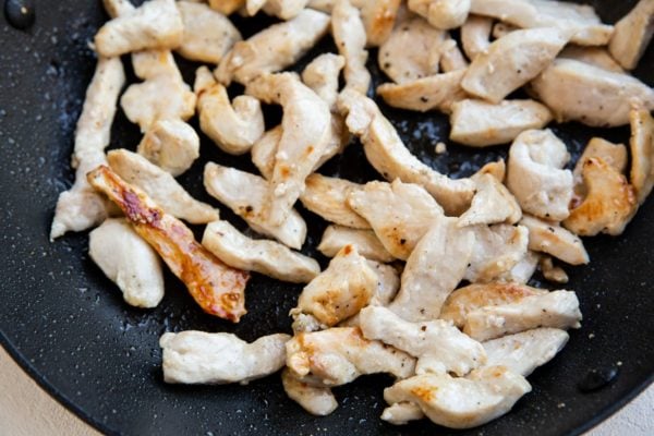 chicken browning in a skillet