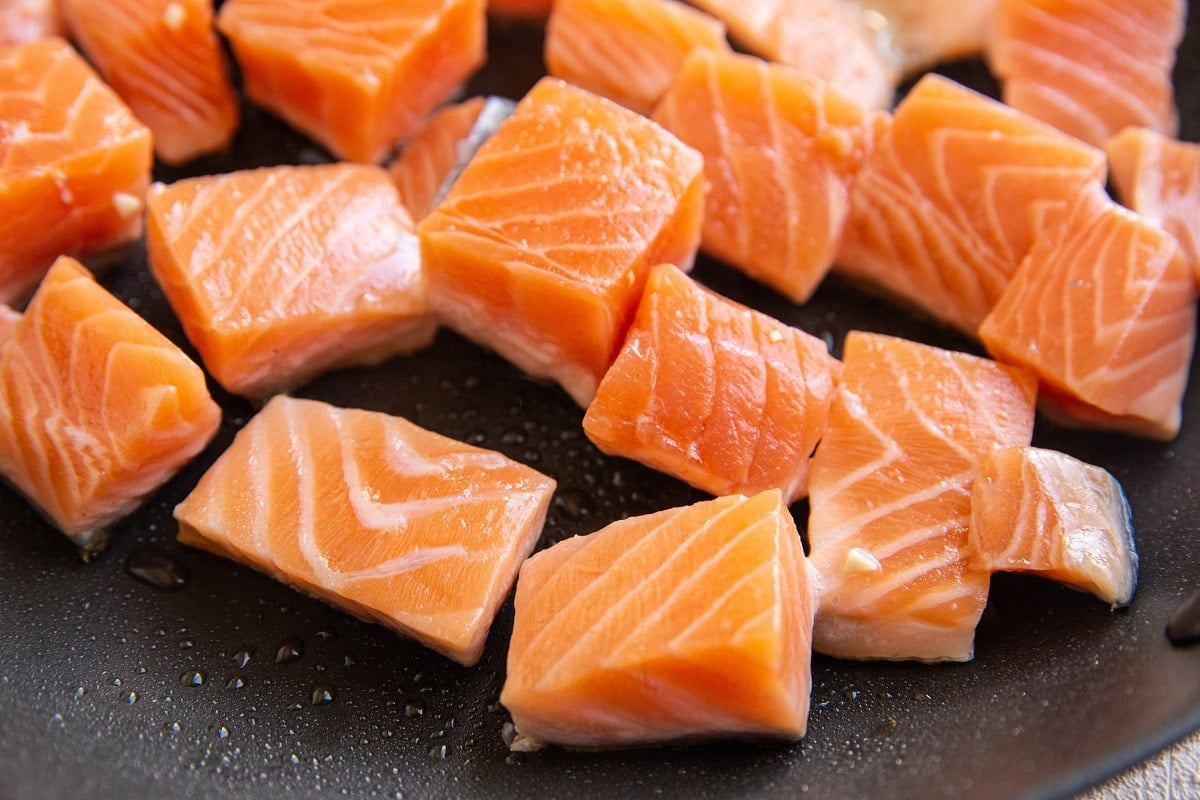 Salmon chunks cooking in a skillet