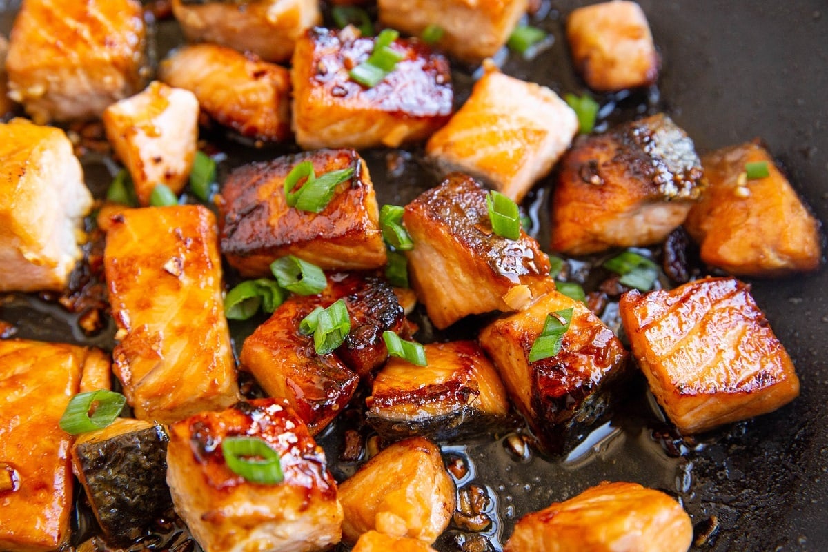 Asian salmon cooking in a skillet