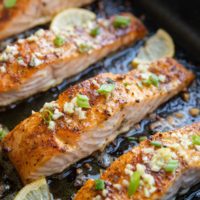 big roasting pan with finished garlic butter baked salmon
