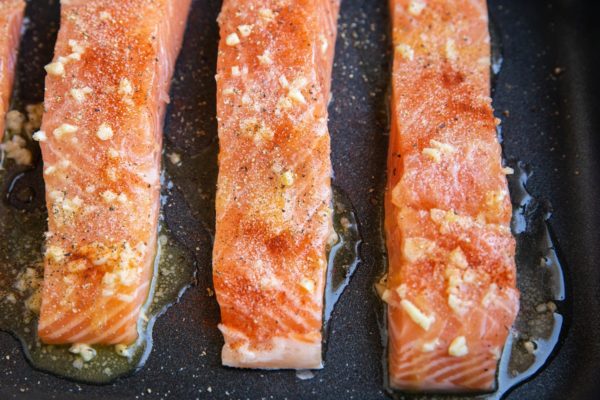 Sprinkle salmon with seasoning
