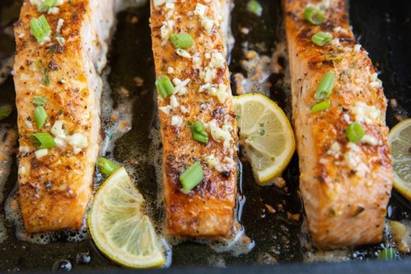 horizontal photo of baked salmon with butter and garlic