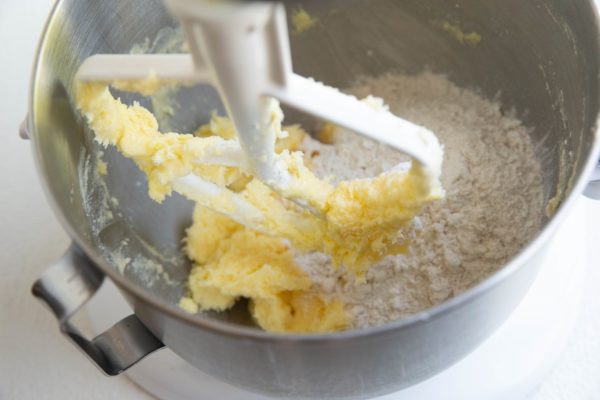 wet ingredients and dry ingredients in a stand mixer, ready to be mixed