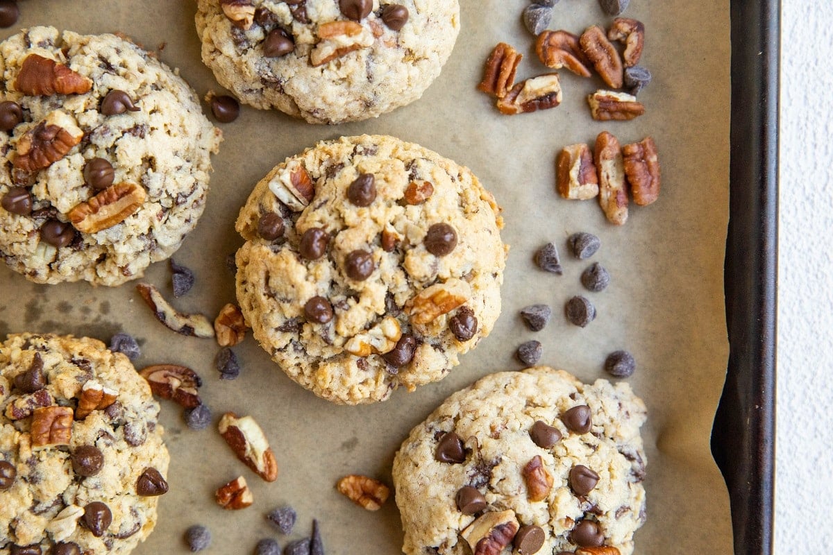 cookie sheet with chocolate chip cookies with pecans and chocolate chips