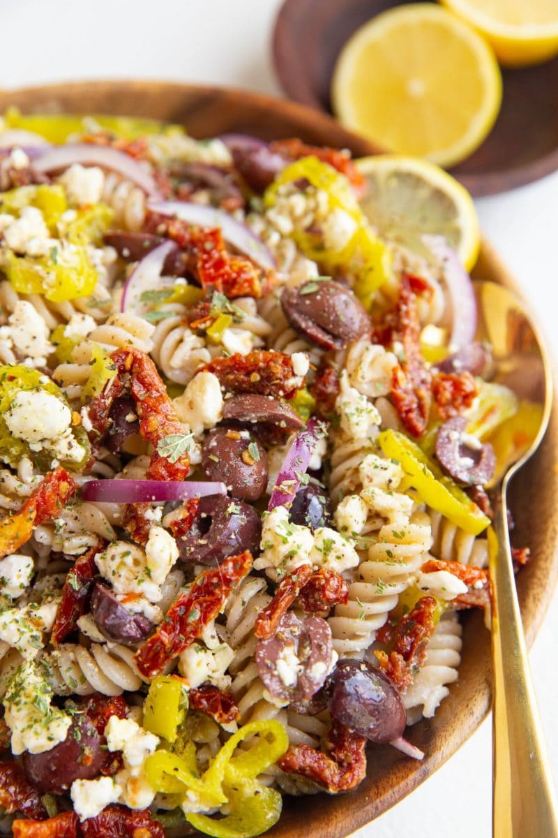 angle shot of wood bowl of Italian pasta salad